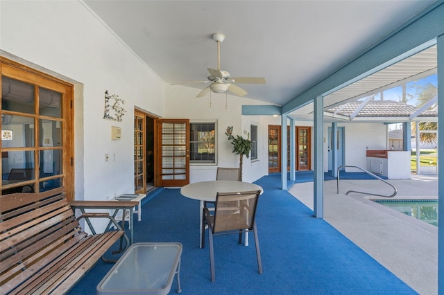 sunroom with plenty of natural light, ceiling fan, lofted ceiling, and a hot tub