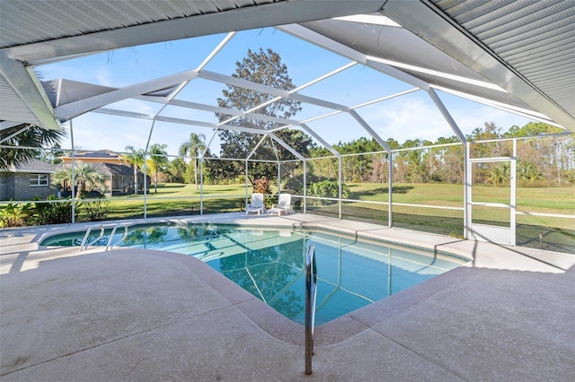 view of swimming pool featuring a lawn, a lanai, and a patio