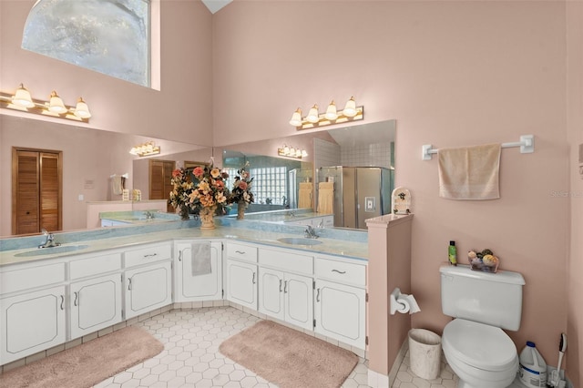 bathroom with tile patterned flooring, vanity, and walk in shower