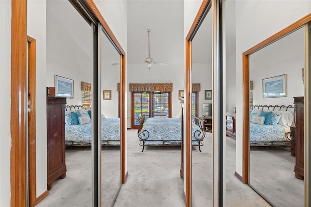 corridor with a towering ceiling and light carpet