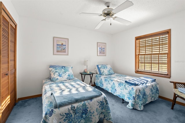 carpeted bedroom with ceiling fan, a closet, and a textured ceiling