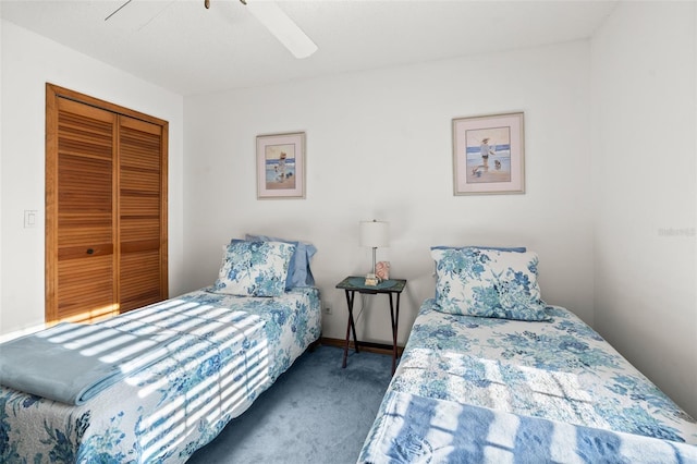 bedroom featuring ceiling fan, a closet, and dark carpet