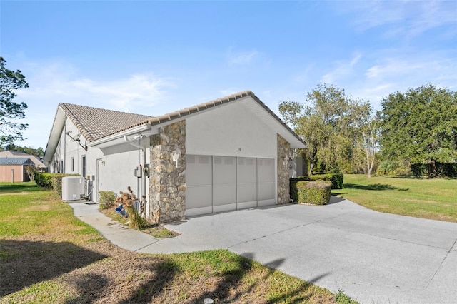 view of property exterior with a yard and a garage