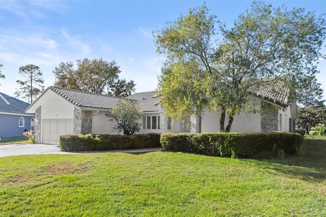 view of front of house with a front yard and a garage