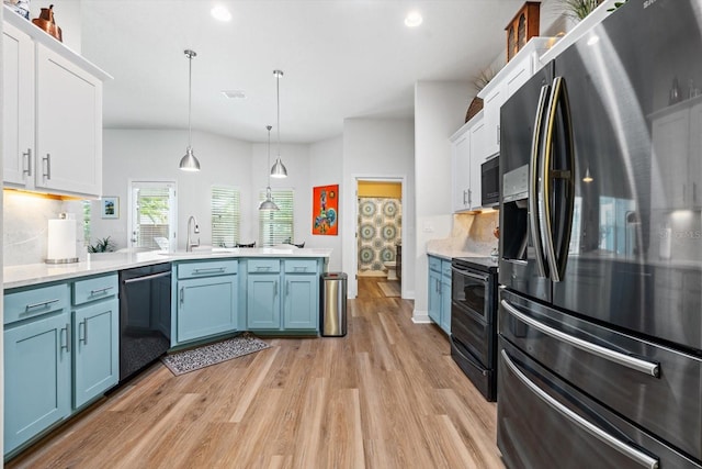6 Lindsay Dr, Palm Coast, FL 32137 - kitchen with fridge with ice dispenser, black microwave, double oven range, dishwashing machine, and a peninsula