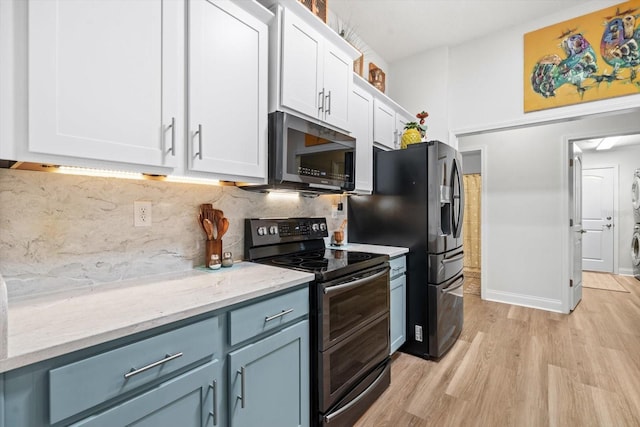 6 Lindsay Dr, Palm Coast, FL 32137 - kitchen featuring appliances with stainless steel finishes, white cabinetry, light wood finished floors, decorative backsplash, and light stone countertops