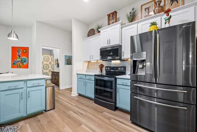 6 Lindsay Dr, Palm Coast, FL 32137 - kitchen with appliances with stainless steel finishes, blue cabinets, light countertops, and decorative backsplash