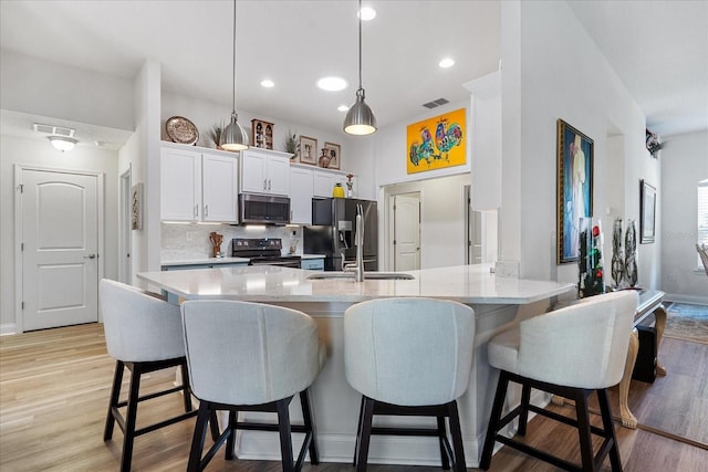 6 Lindsay Dr, Palm Coast, FL 32137 - kitchen featuring stainless steel microwave, electric range, fridge with ice dispenser, backsplash, and a kitchen breakfast bar