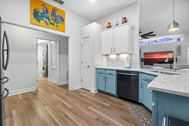 6 Lindsay Dr, Palm Coast, FL 32137 - kitchen with appliances with stainless steel finishes, blue cabinets, a sink, stacked washing machine and dryer, and ceiling fan