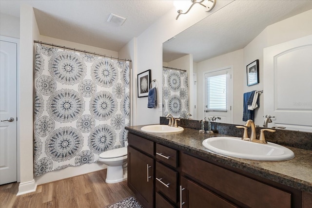 6 Lindsay Dr, Palm Coast, FL 32137 - full bath with wood finished floors, double vanity, toilet, and a shower with curtain