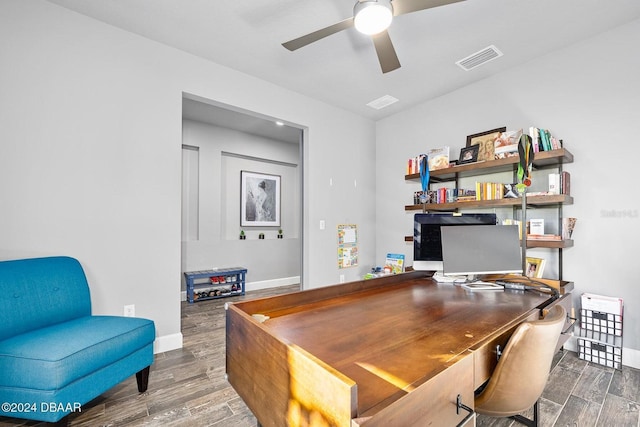 office with dark hardwood / wood-style floors and ceiling fan