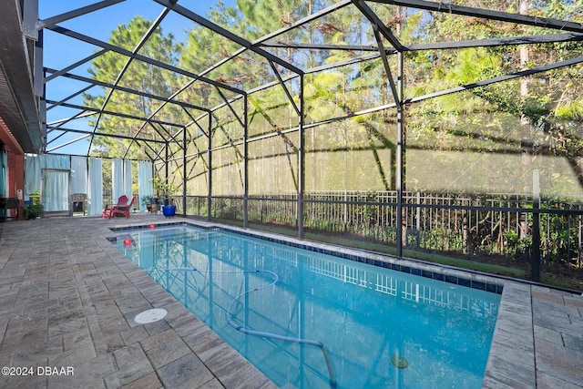 view of swimming pool with a patio area and a lanai