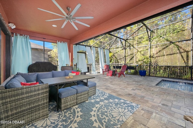 view of patio / terrace with an outdoor living space, a hot tub, glass enclosure, and ceiling fan