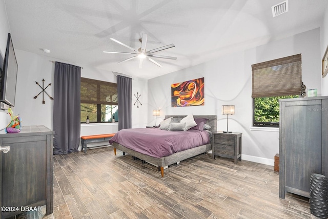 bedroom with ceiling fan and wood-type flooring