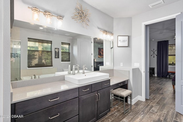 bathroom with vanity, hardwood / wood-style flooring, and independent shower and bath