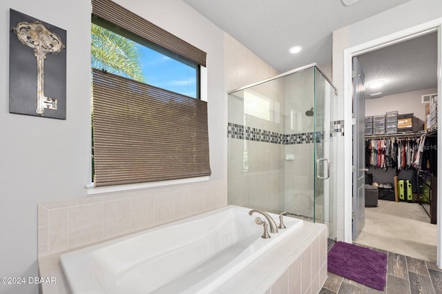 bathroom featuring wood-type flooring and plus walk in shower