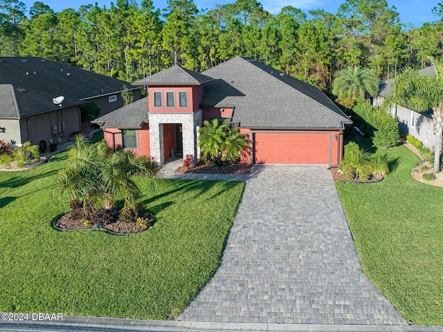 view of front facade with a garage and a front lawn