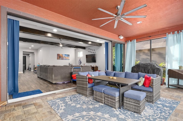 living room featuring beam ceiling, hardwood / wood-style floors, and a textured ceiling