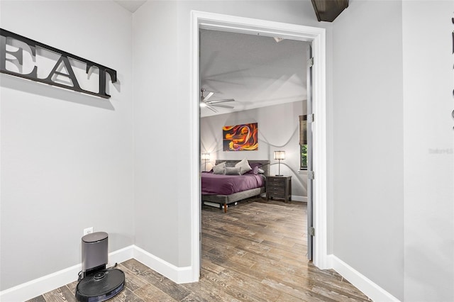 corridor with hardwood / wood-style flooring