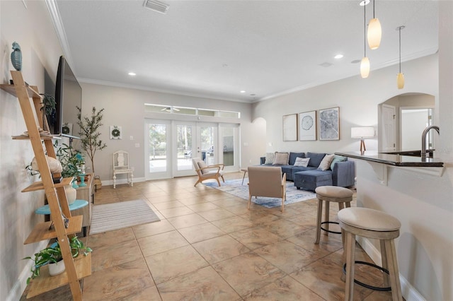 living room with french doors and ornamental molding