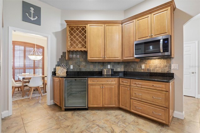 kitchen with dark stone countertops, beverage cooler, and tasteful backsplash