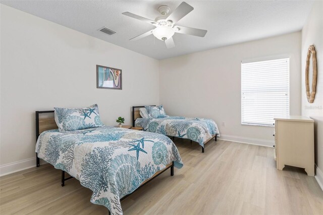 bedroom featuring ceiling fan and light hardwood / wood-style flooring