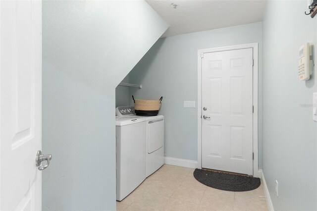 washroom with separate washer and dryer and light tile patterned floors