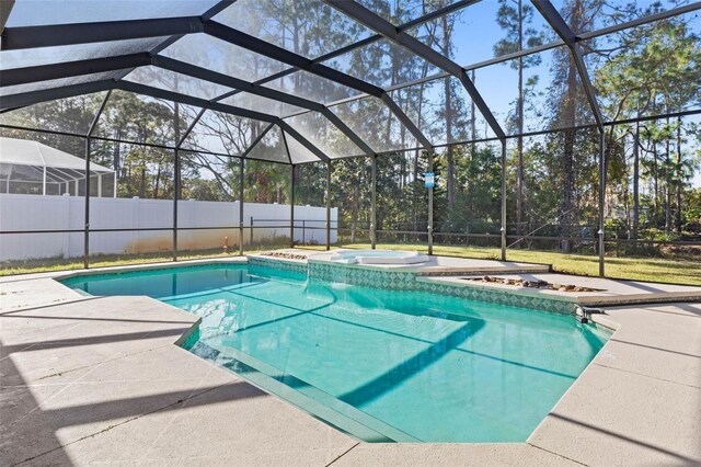 view of swimming pool featuring an in ground hot tub, a patio area, and a lanai