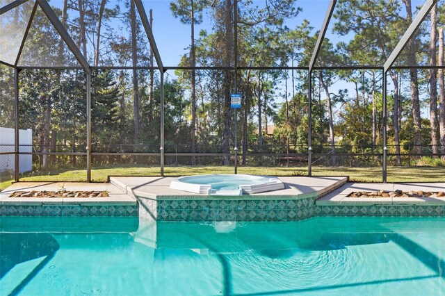 view of pool featuring an in ground hot tub and glass enclosure