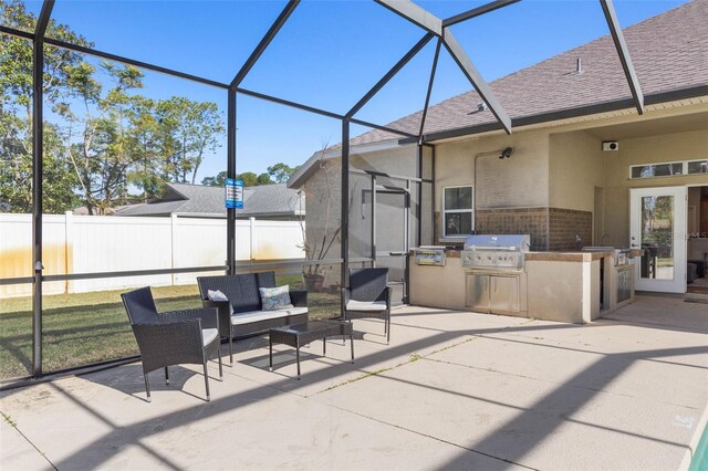 view of patio / terrace featuring an outdoor living space, area for grilling, a lanai, and a grill