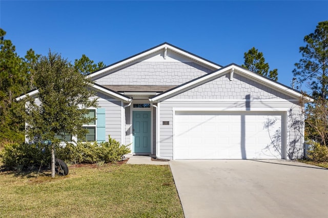 view of front of home with a front yard and a garage