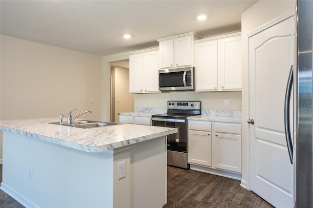 kitchen featuring white cabinetry, sink, dark hardwood / wood-style flooring, a center island with sink, and appliances with stainless steel finishes