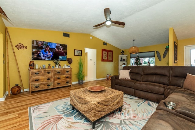 living room featuring ceiling fan, light hardwood / wood-style floors, and lofted ceiling