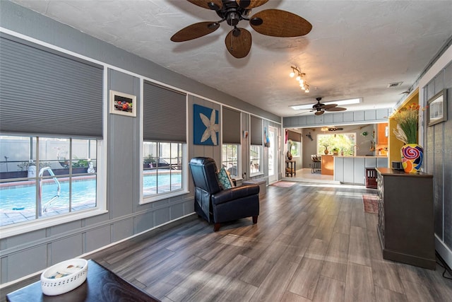 14 Fort Caroline Ln, Palm Coast, FL 32137 - living area featuring a ceiling fan, wood finished floors, and healthy amount of natural light