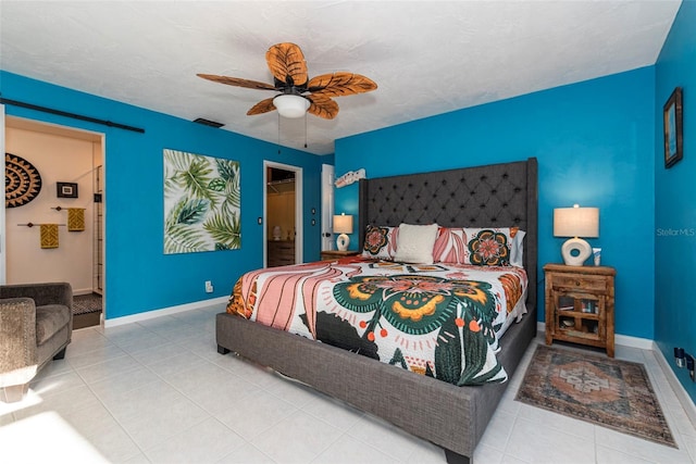 bedroom featuring ceiling fan, light tile patterned flooring, a spacious closet, and a closet