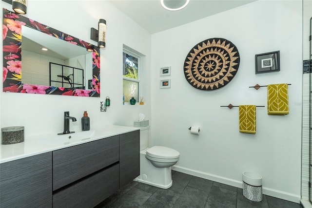 bathroom with walk in shower, vanity, and toilet