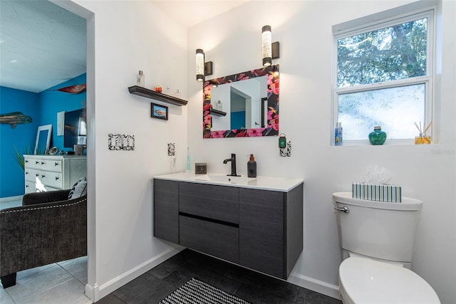 bathroom with tile patterned flooring, vanity, and toilet