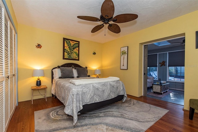 bedroom featuring dark hardwood / wood-style flooring, a closet, and ceiling fan