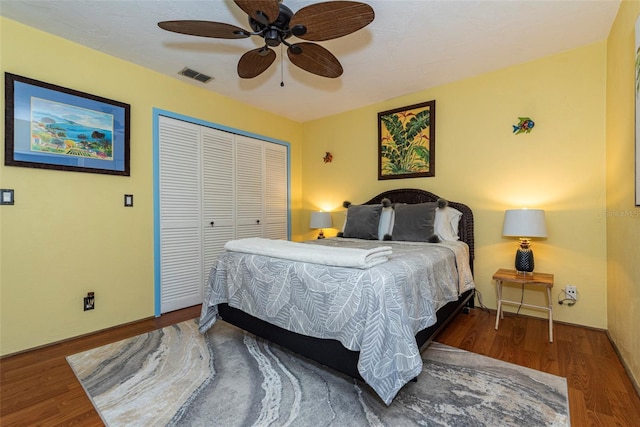 bedroom featuring ceiling fan, a closet, and hardwood / wood-style floors