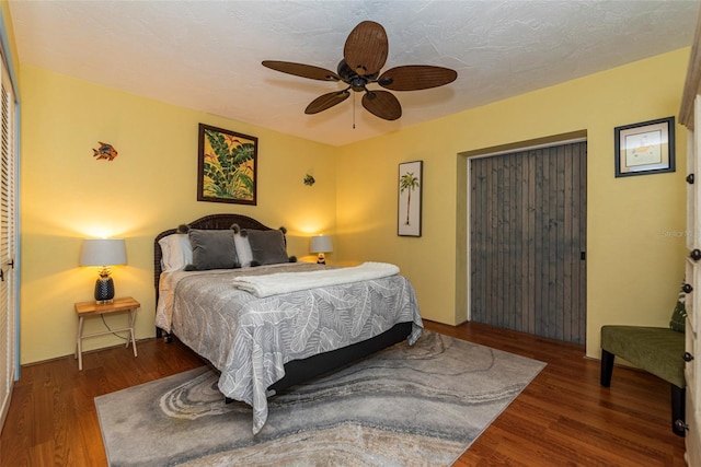 bedroom featuring ceiling fan and dark wood-type flooring