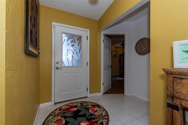 tiled foyer entrance featuring ceiling fan