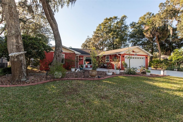 ranch-style home with a garage and a front lawn