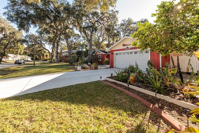 14 Fort Caroline Ln, Palm Coast, FL 32137 - view of grassy yard featuring driveway and an attached garage