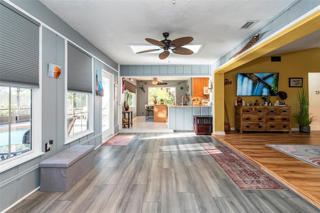 reception area with a skylight, ceiling fan, and sink