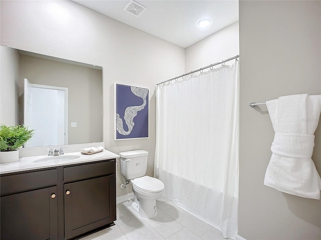 full bathroom with tile patterned floors, vanity, shower / tub combo, and toilet