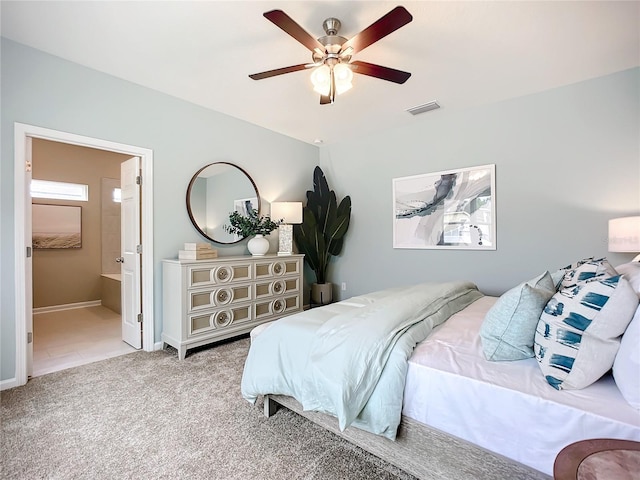 carpeted bedroom with ceiling fan and connected bathroom