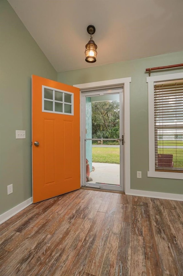 foyer with hardwood / wood-style floors and lofted ceiling