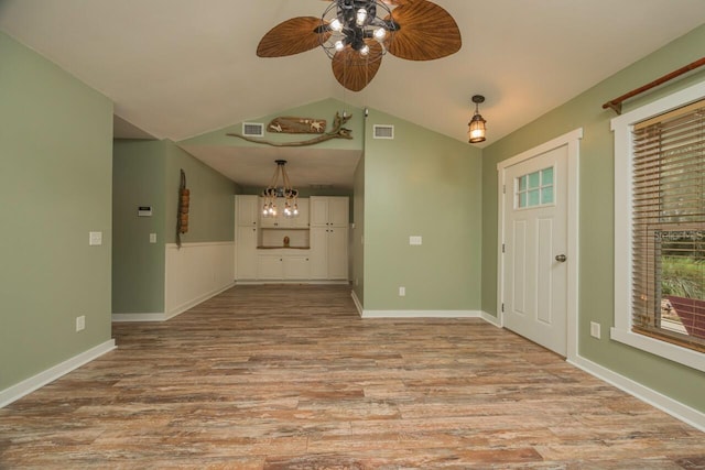 entrance foyer with ceiling fan, vaulted ceiling, and light hardwood / wood-style flooring