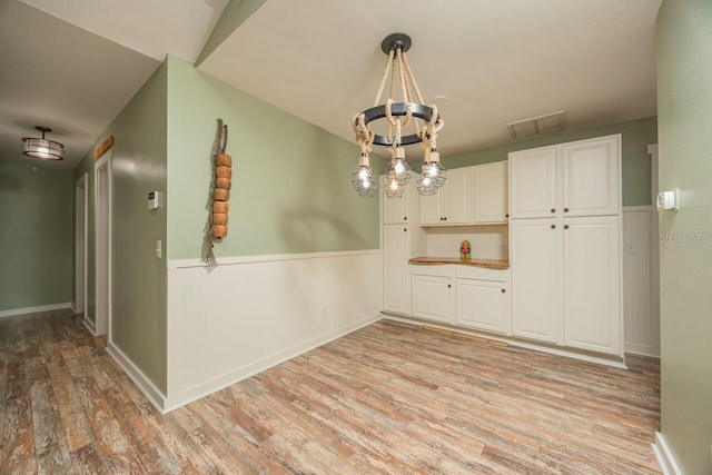 unfurnished dining area featuring light hardwood / wood-style flooring