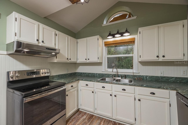 kitchen featuring appliances with stainless steel finishes, white cabinetry, lofted ceiling, and sink